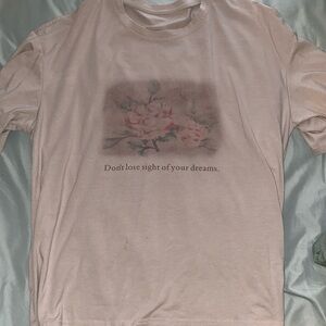 Cream/tan colored tee shirt w/ flower design
